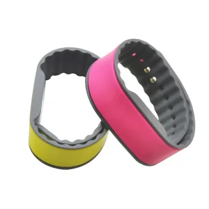 Zwei RFID Custom Armbänder aus rechteckigem Silikon, eine rosa und die andere gelb, mit einer leichten Überlappung angeordnet und mit Blick auf das Innenfutter.