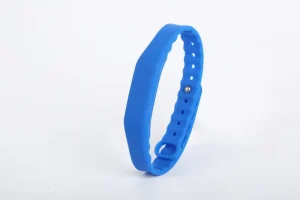 Mkanda wa RFID Wrist ulio na kamba ya mpira wa bluu inayoweza kubadilishwa na kifungo cha chuma, imeonyeshwa kwenye mandharinyuma nyeupe.