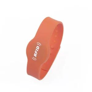 An orange Wristband RFID designed for access control, featuring the text "(RFID)" printed on its surface.